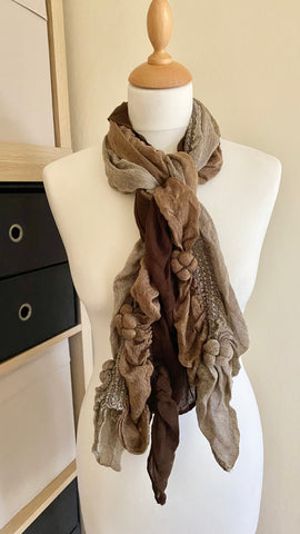 Stay warm and stylish in this light, soft cosy smart casual scarf. Crafted in a blend of taupe, brown, and cream shades, this 100% viscose scarf is a versatile addition to any wardrobe. Perfect for any occasion, the scarf measures 120cm x 48cm.