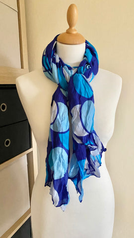 This beautiful scarf is crafted from 100% viscose for a soft and comfortable feel. The vibrant blue circle print is very crease resistant and measures 70” x 42” — ideal for a variety of looks. A perfect accessory for any outfit, you'll enjoy the beauty of this scarf for years to come.