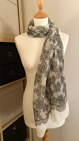 This luxurious elegant lace design scarf is made from 100% viscose, with a beautiful soft white base and a detailed black lace pattern. Featuring raw edged detailing and an impressive 200cm x 100cm size, this scarf is super soft and resistant to creasing. Perfect for wearing all year round.