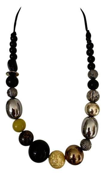 This contemporary necklace features bold black, silver grey, and yellow colours to add a pop of vibrancy to any outfit. With an adjustable extension chain and easy overhead fit, it offers both style and convenience, perfect for any fashion-forward individual looking to make a statement.