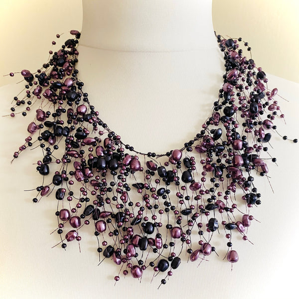 These stunning contemporary necklaces are lightweight, making them comfortable to wear for extended periods, the droplets come in varying tones, adding a modern touch to any outfit. With an adjustable extension chain and secure lobster claw clasp, these necklaces are available in shades of lilac, silver and grey, and silver and black. Elevate your style with these effortless statement pieces.