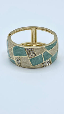 Faux gold bracelet with aqua asymmetric panels with faux diamonds opening spring closure
