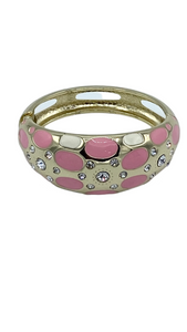 A rose pink bracelet with dotted design and adorned with small  faux diamonds featuring a gold-tone plating and a spring clasp.